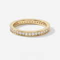 Yellow gold diamond eternity band ring with round brilliant diamonds in a polished luxury wedding band design