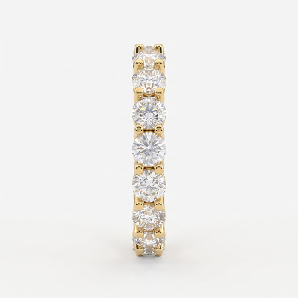 Side profile of a yellow gold diamond eternity ring highlighting the shared U-prong setting and polished comfort-fit band.