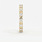 Side profile of yellow gold diamond eternity ring showing open gallery and shared-prong craftsmanship