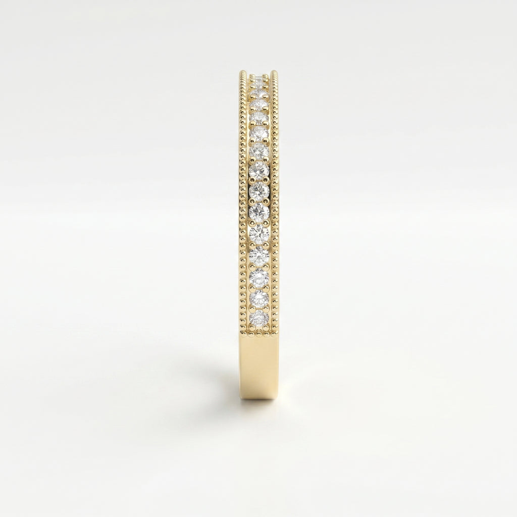 Side profile of yellow gold diamond wedding band showing shared prong setting and milgrain craftsmanship