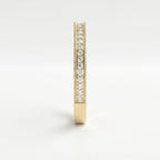 Side profile of yellow gold diamond wedding band showing shared prong setting and milgrain craftsmanship