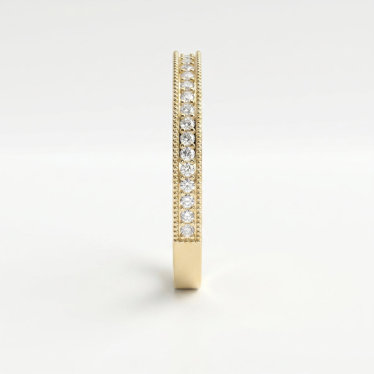 Side profile of yellow gold diamond wedding band showing shared prong setting and milgrain craftsmanship