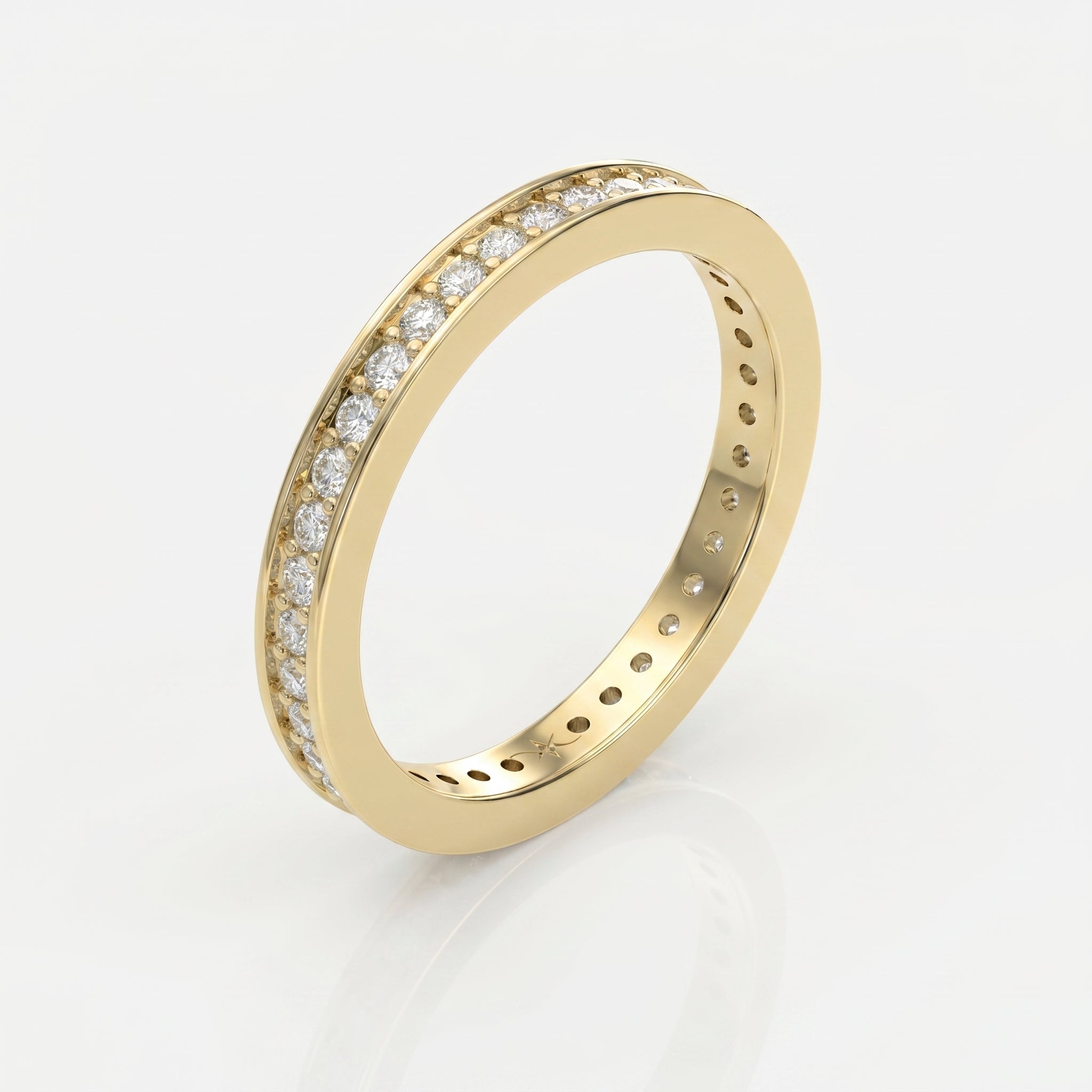 Top view of yellow gold eternity ring featuring round brilliant diamonds in a sleek stacking band design