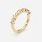 45-degree view of yellow gold diamond eternity ring featuring secure bezel settings and polished finish