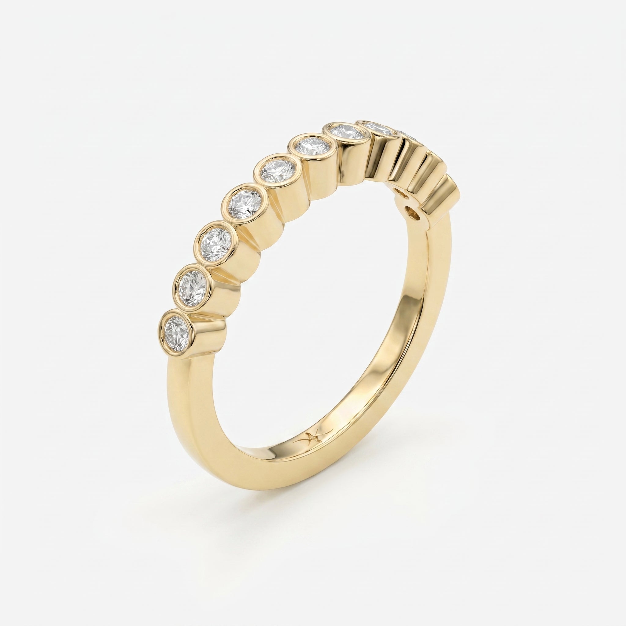 45-degree view of yellow gold diamond eternity ring featuring secure bezel settings and polished finish