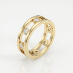 Yellow gold designer diamond ring with floating bezel-set stones shown at 45-degree angle on white background.