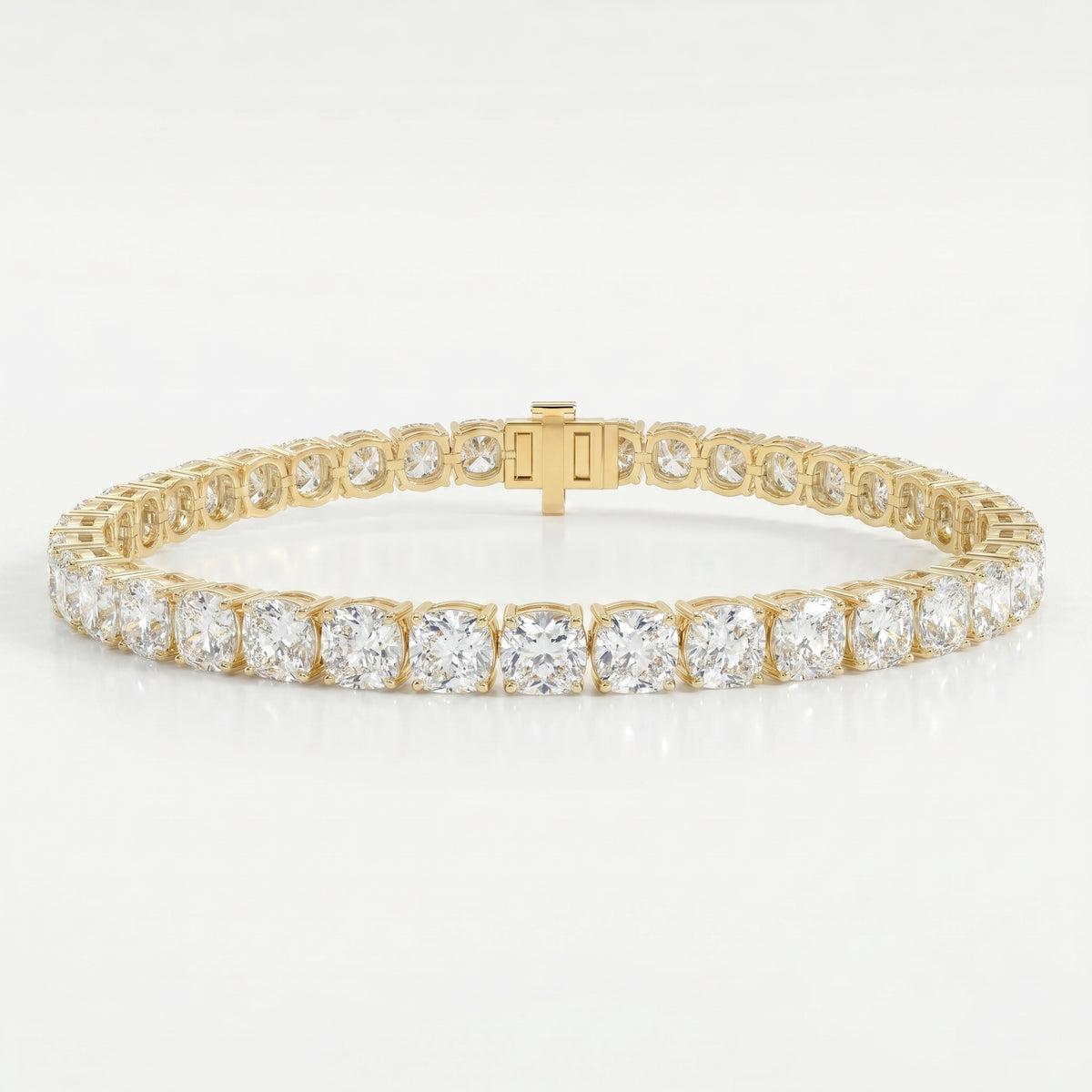 Luxury yellow gold tennis bracelet featuring brilliant Cushion-cut diamonds in a secure prong setting on white background.