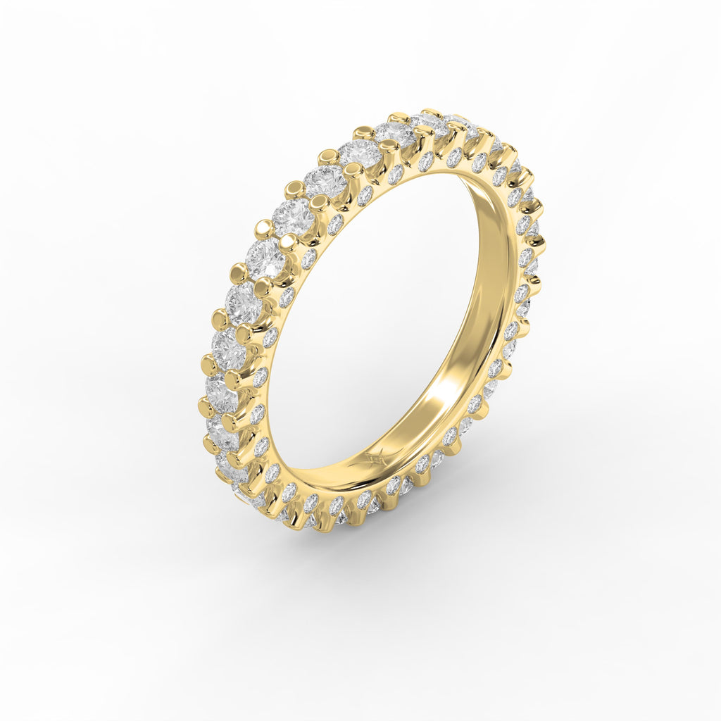 Luxury yellow gold eternity ring featuring round brilliant diamonds in a shared prong setting viewed at a 45-degree angle.