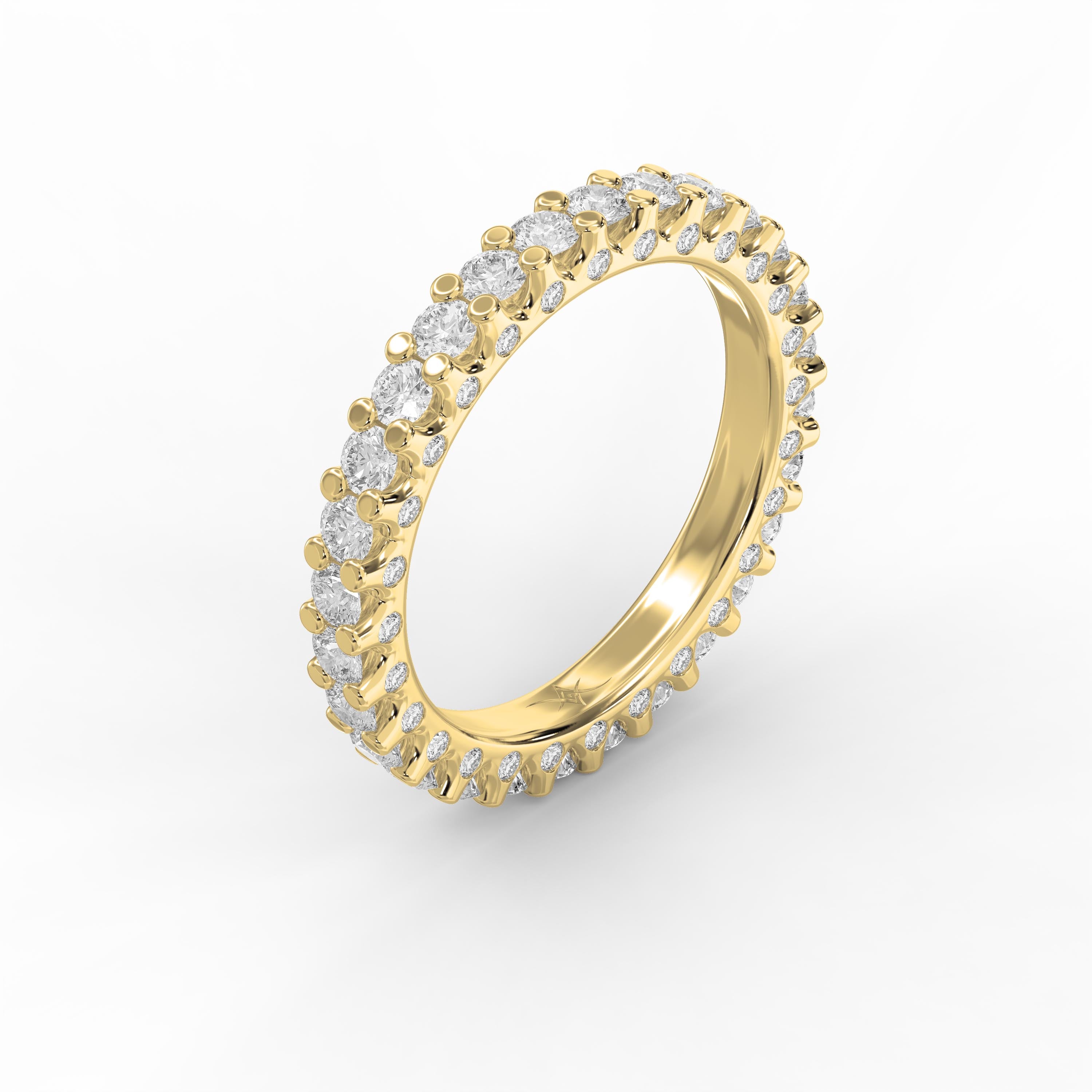 Luxury yellow gold eternity ring featuring round brilliant diamonds in a shared prong setting viewed at a 45-degree angle.
