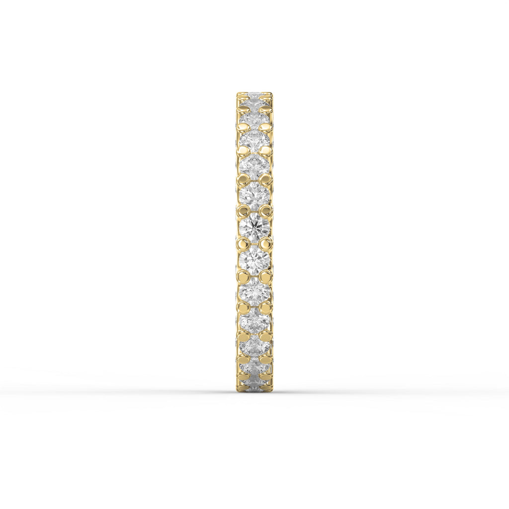 Side profile of a yellow gold eternity band showcasing shared prong diamond setting and polished gold finish.
