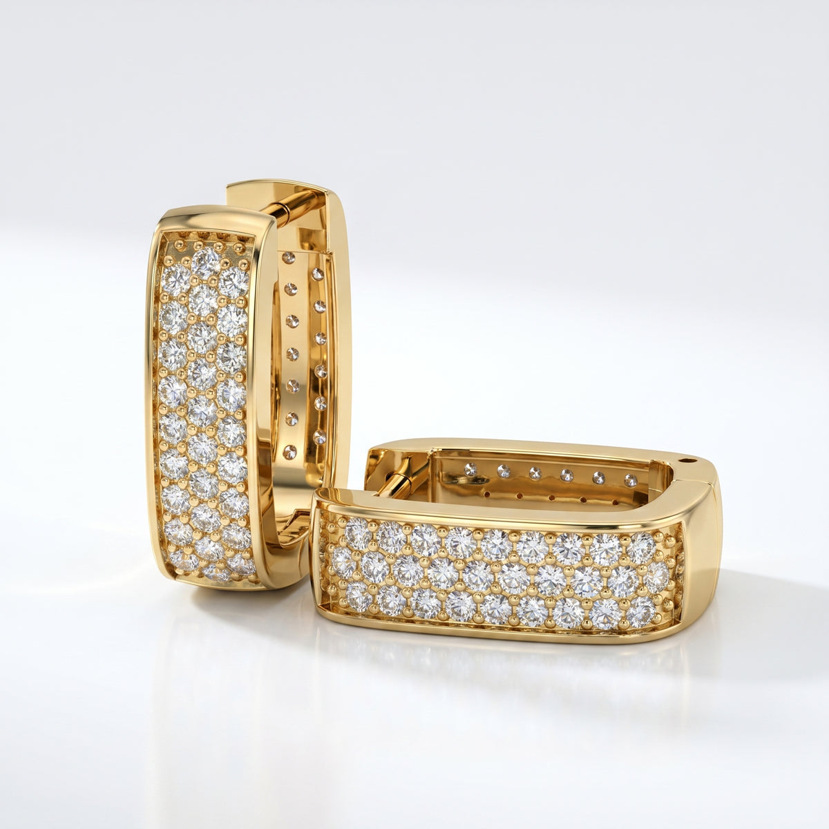 Woman wearing Yellow gold pavé huggie earrings styled for modern everyday luxury jewelry fashion