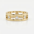 Modern yellow gold open-band diamond ring with bezel-set round diamonds, luxury fine jewelry front view on white background.