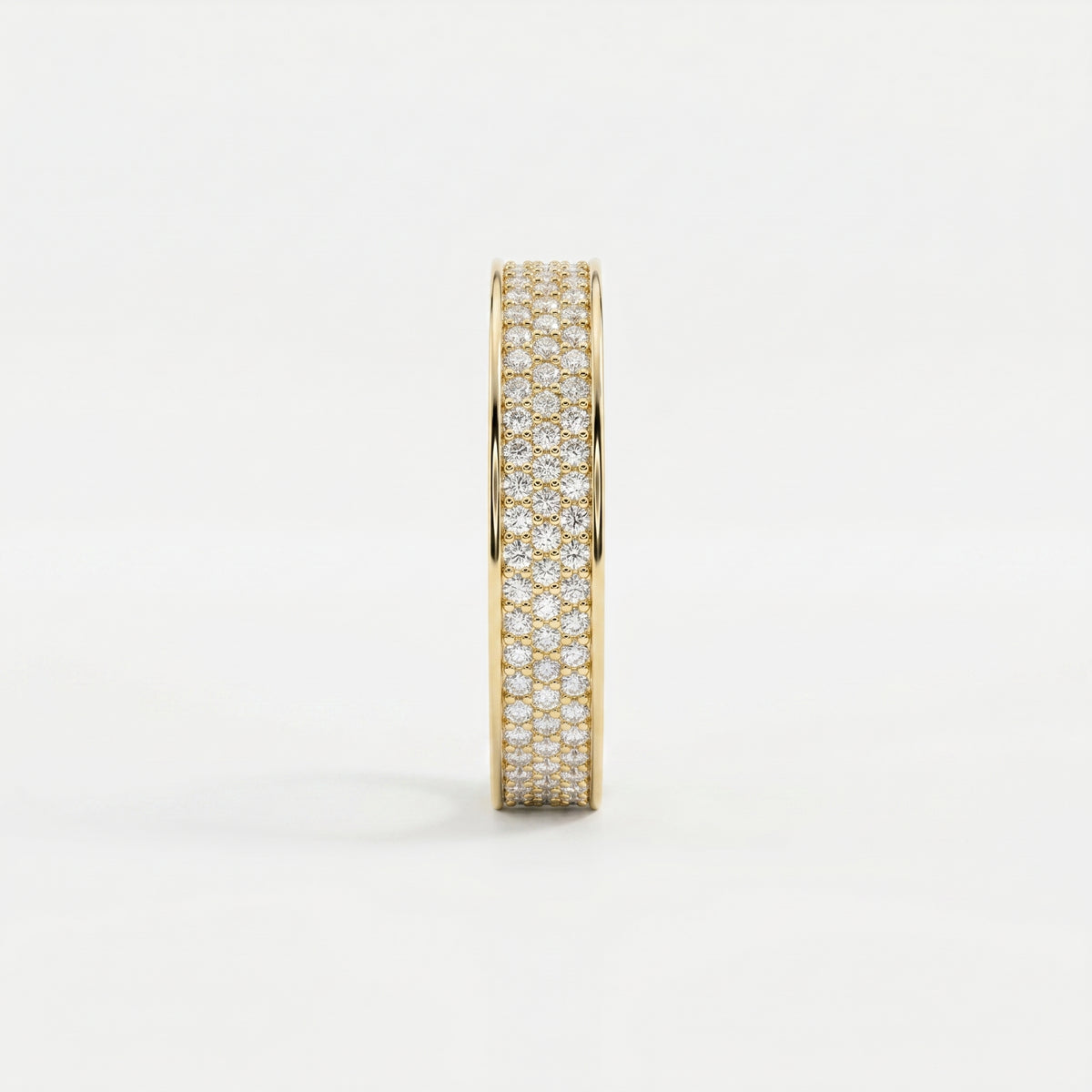 Side profile of yellow gold diamond eternity band showing pavé setting and elegant wide-band construction