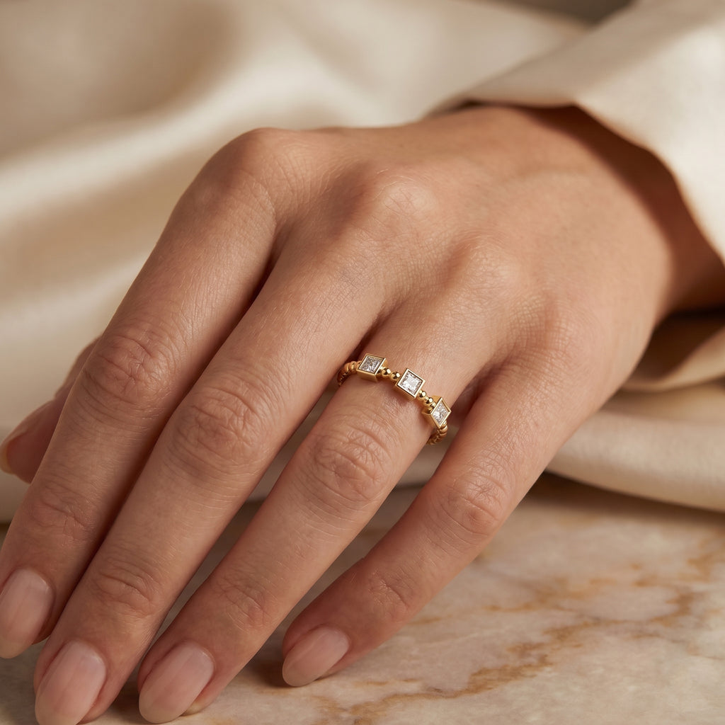 Yellow gold geometric ring styled with stacking bands for a modern layered jewelry look and everyday wear