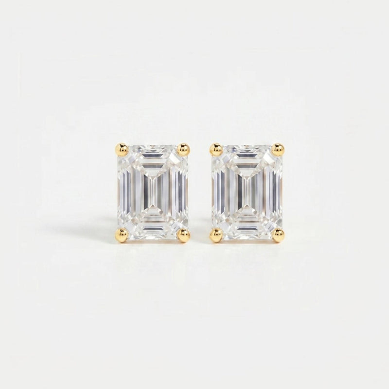 Pair of diamond stud earrings on a light gray background